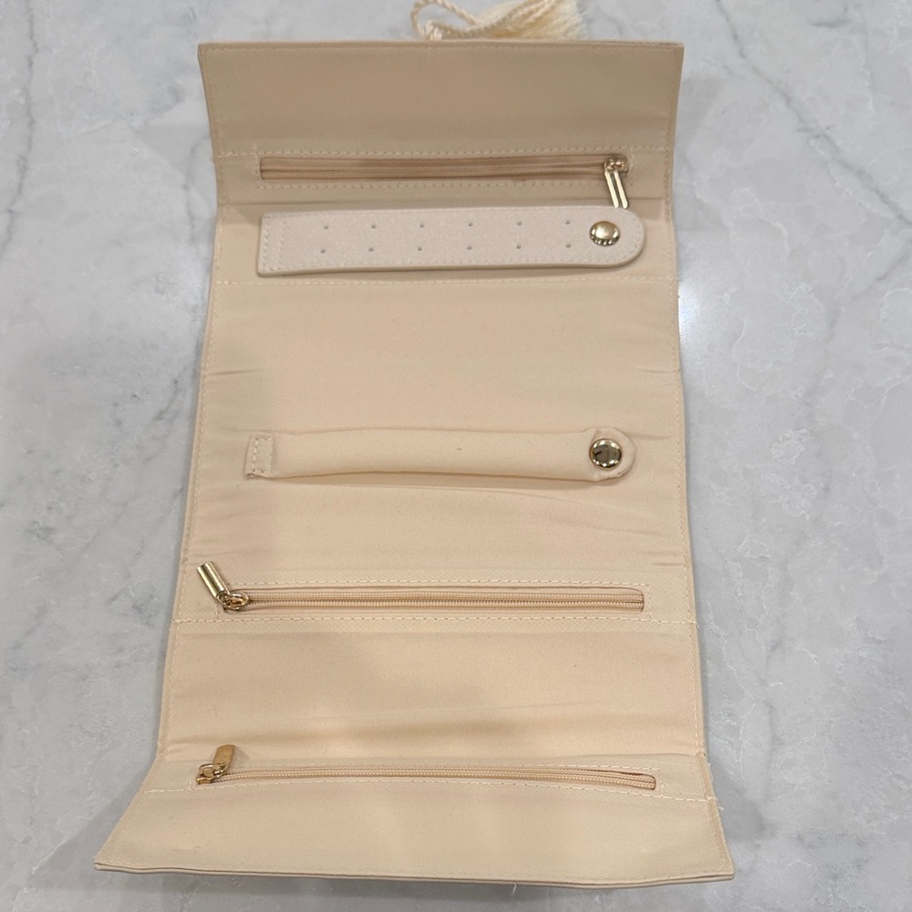 Elegant Cream Jewelry Roll with Tassel Detail